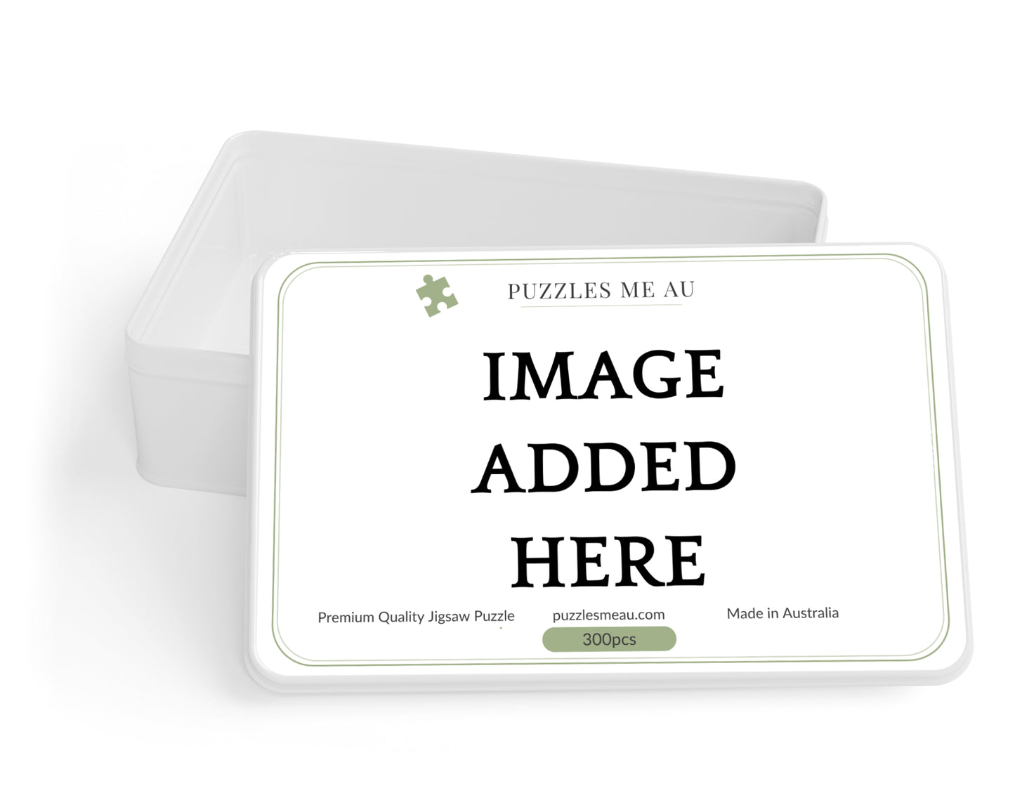 A white rectangular jigsaw puzzle tin with a matching lid behind it on a white background. The front of the tin reads 'PUZZLES ME AU' and prominently says 'IMAGE ADDED HERE' in black text, with small product details below.